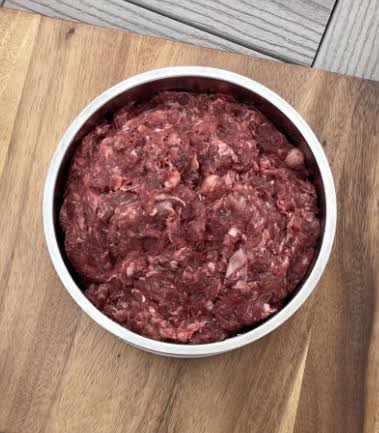 Bowl of Midwest Legacy Beef BLT and Bone raw dog food prepared for feeding