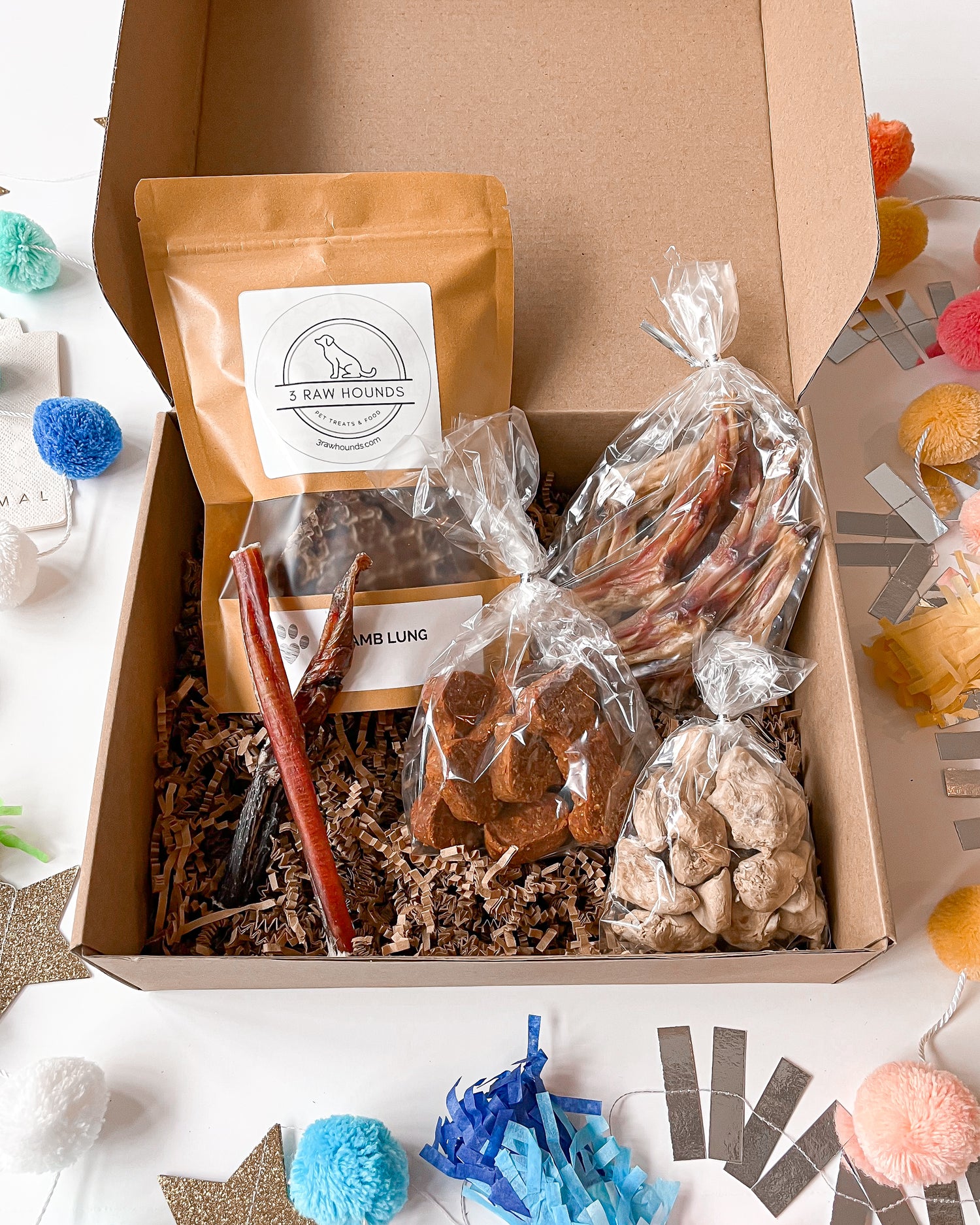 Tiny Tails party treat box for small dogs with chicken hearts, bully sticks and pumpkin treats.