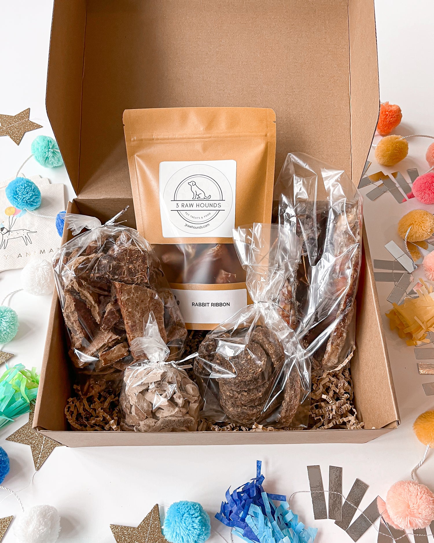 Wild Roots Box – natural novel protein dog treat variety pack for sensitive dogs featuring rabbit jerky, venison liver, bison trachea, duck cookies, and bison lung.