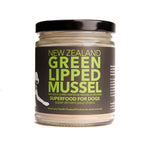 A jar of North Hound Life New Zealand Green Lipped Mussel Powder, with a label that has green text and an image of a dog. The product is presented as a superfood for dogs.